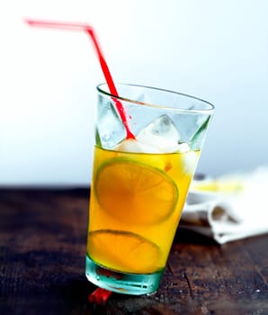 Juicy Drink with a straw on a wooden, ancient plate