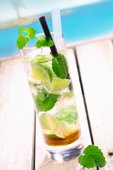 Mojito Drink standing on a bridge near the pacific sea. For tropical Cocktail concepts. More beverages in my portofolio.
