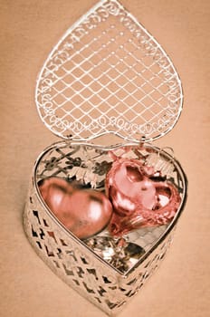 Valentines or anniversary gift of romantic hearts nestled inside a delicate silver filigree heart-shaped gift box