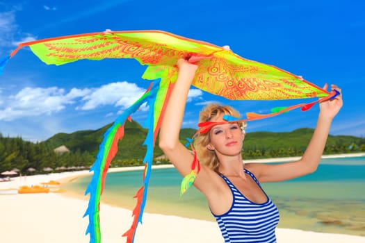 Young woman with kite on the beach