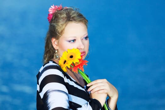 Beautiful woman with flowers in the sea