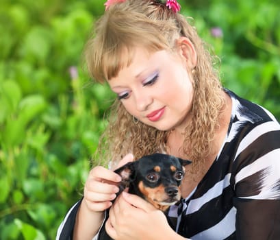 Beautiful young woman with her pet dog outdoor