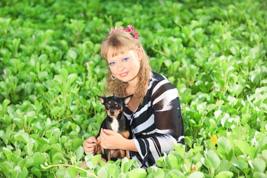 Beautiful young woman with her pet dog outdoor