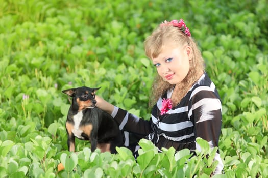 Beautiful young woman with her pet dog outdoor