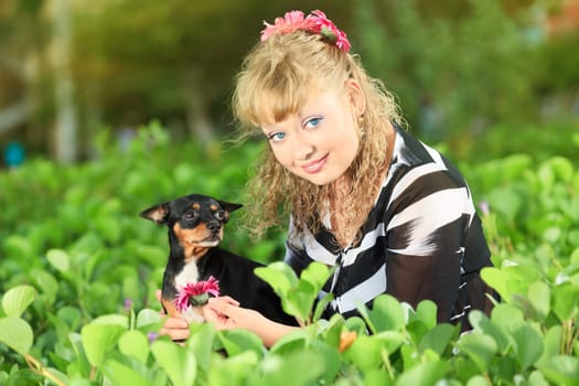 Beautiful young woman with her pet dog outdoor