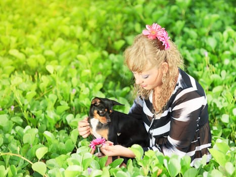 Beautiful young woman with her pet dog outdoor