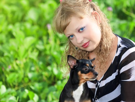 Beautiful young woman with her pet dog outdoor