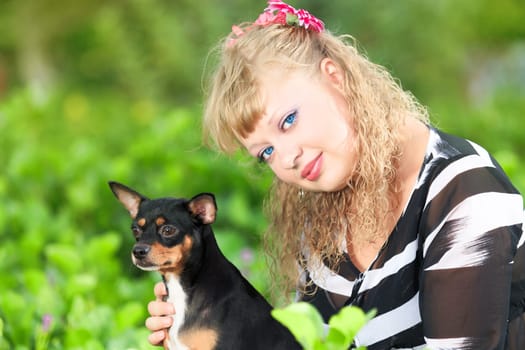 Beautiful young woman with her pet dog outdoor