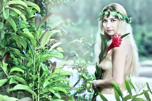 Beautiful woman as a forest nymph on the river