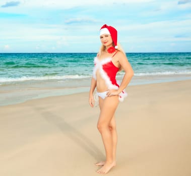 Sexy female Santa at the tropical beach
