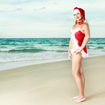 Beauriful sexy Santa at the tropical beach