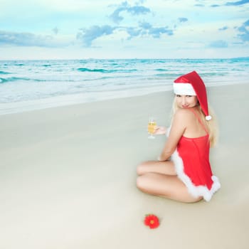 Sexy Santa&#039 s helper at the tropical beach
