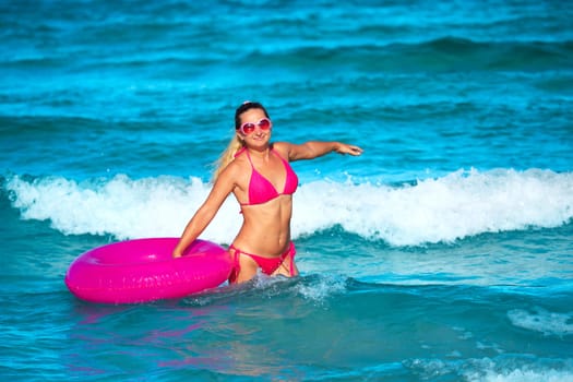 Woman with raft on the tropical beach