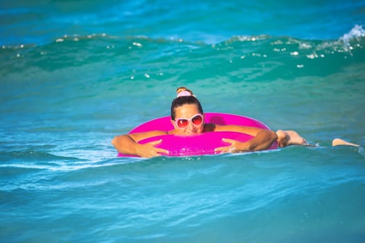 Woman with inner tube on the tropical beach