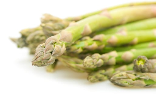 Spears of Fresh Uncooked Asparagus on White Background - Shallow Depth of Field