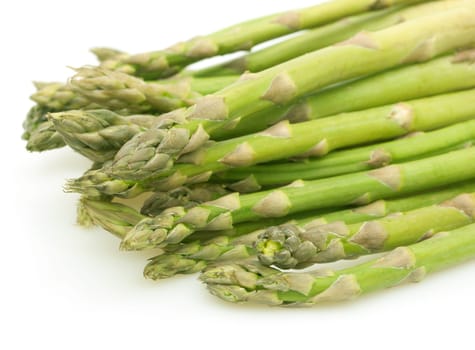 Spears of Fresh Uncooked Asparagus on White Background - Shallow Depth of Field