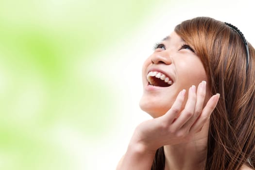 Laughing Asian woman looking up