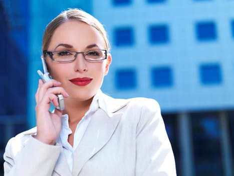 Beautiful business woman on the phone at modern building