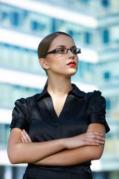 Beautiful business woman standing outdoor modern building
