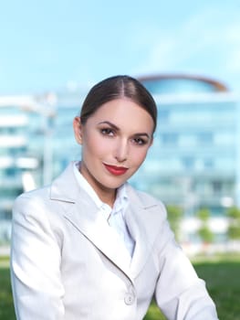 Beautiful Business woman sitting on grass