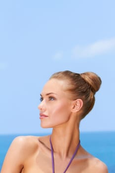Portrait of gorgeous young woman smiling while looking at her right