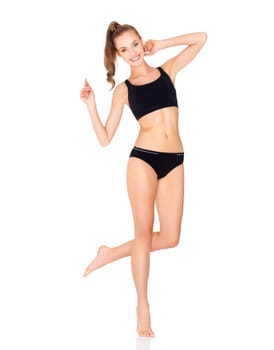 Fitness woman in black sports clothes isolated on white