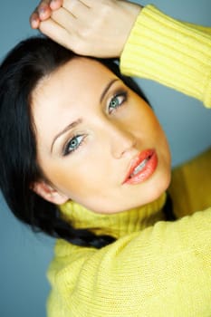 Portrait of beautiful woman wearing yellow sweater