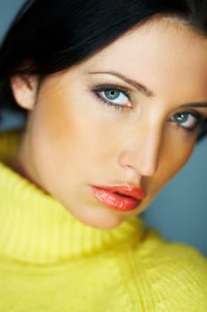 Portrait of beautiful woman wearing yellow sweater