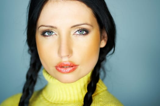 Portrait of beautiful woman wearing yellow sweater