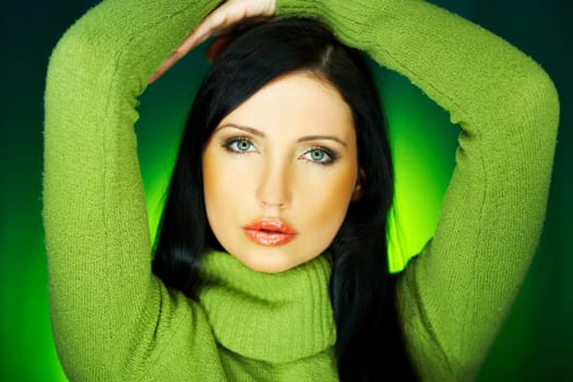 Portrait of beautiful woman wearing green sweater