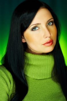 Portrait of beautiful woman wearing green sweater