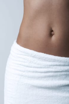 Beautiful womans body part wearing white towel on clear background