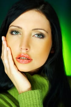 Portrait of beautiful woman wearing green sweater