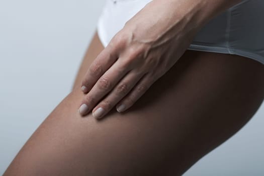 Beautiful womans body part wearing white underwear on clear background