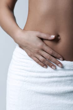 Beautiful womans body part wearing white towel on clear background