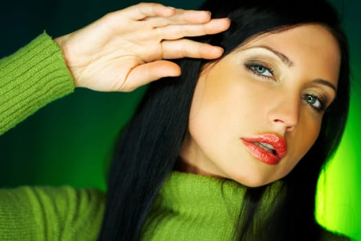 Portrait of beautiful woman wearing green sweater