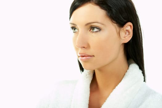 Portrait of Fresh and Beautiful brunette woman on white background wearing white bathrobe