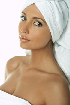 Portrait of Fresh and Beautiful brunette woman wearing white towel on her head