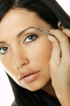 Portrait of Beautiful brunette woman doing daily morning routines (the make up series)