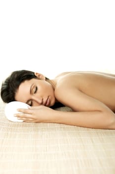Portrait of Fresh and Beautiful brunette woman laying on bamboo mat