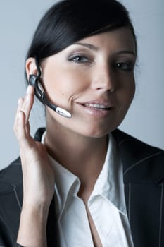 Beautiful and sexy brunette business woman talking telephone. She is isolated on clear background