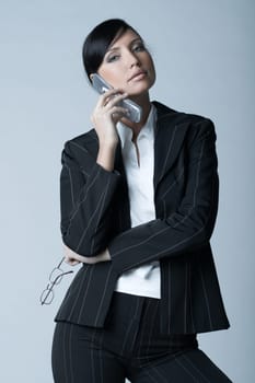 Beautiful brunette business woman talking cell phone isolated on clear background