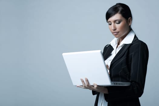 Beautiful brunette business woman with laptop computer isolated on clear background