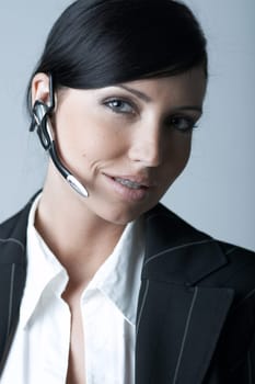 Beautiful and sexy brunette business woman talking telephone. She is isolated on clear background