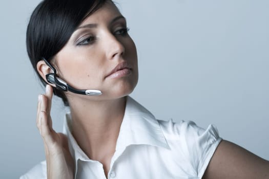 Beautiful and sexy brunette business woman talking telephone. She is isolated on clear background