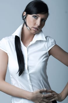 Beautiful brunette business woman with wireless headset isolated on clear background