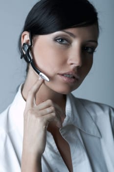 Beautiful brunette business woman with wireless headset isolated on clear background
