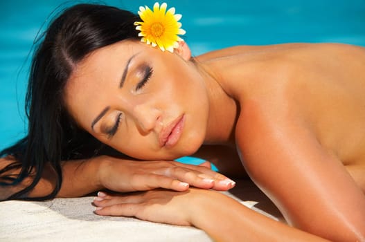 Beautiful young Sexy woman laying during sunbath next to swimming pool