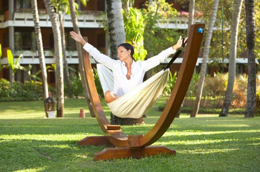 20-25 years woman portrait ralaxing on hammock at exotic surrounding, bali indonesia