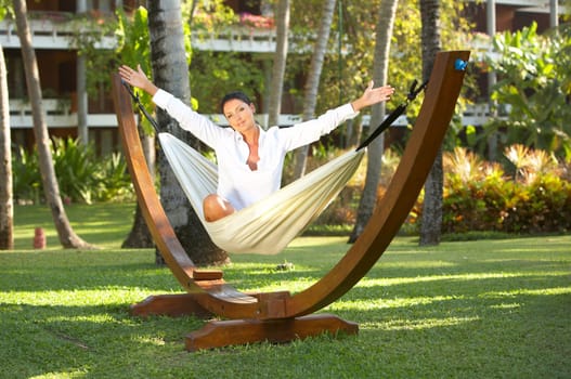 20-25 years woman portrait ralaxing on hammock at exotic surrounding, bali indonesia